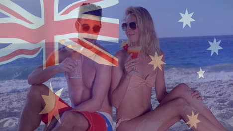 australian flag animation over couple relaxing on beach with cocktails