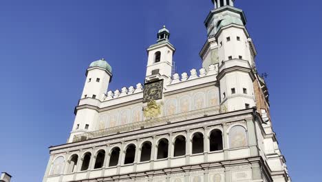 poznań city hall tower with clock and beautiful art