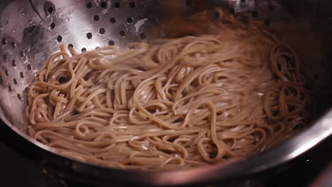 boiled japanese noodles, soba noodles, stirring in boiled noodles