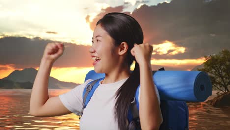 close up side view of asian female hiker with mountaineering backpack screaming goal celebrating the success at a lake