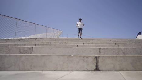 smiling sporty young man running downstairs.