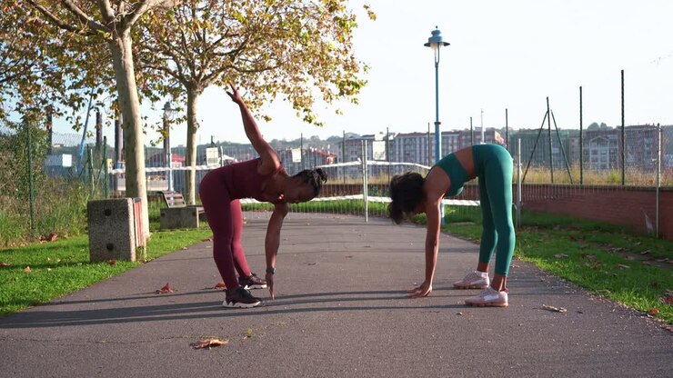 Two Women Exercising in a Park