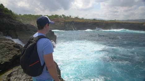 Tourist-Overlooking-Rough-Ocean