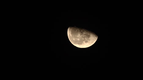 half moon rising in the black sky - time lapse