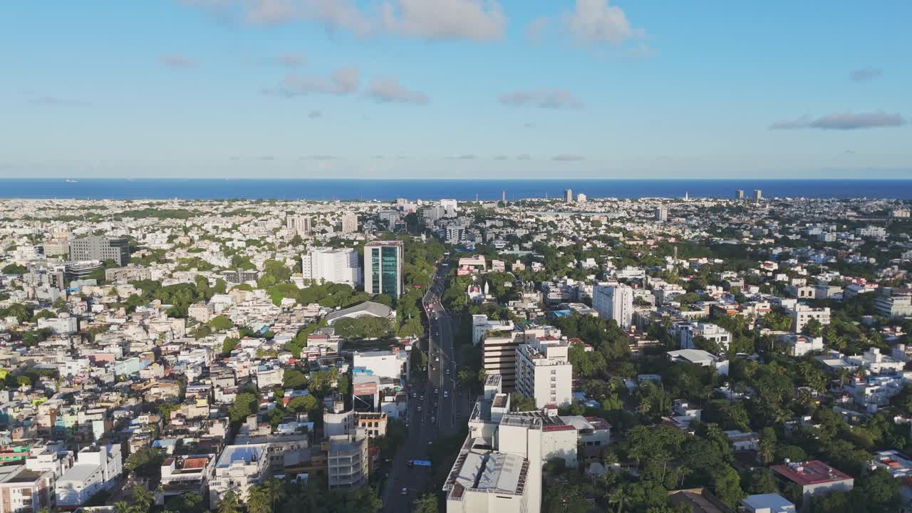 An aerial view of Chennai's Mount Road at sunrise would capture the city's vibrant morning. a golden glow over the Bay of Bengal, highlighting the road's historic architecture and modern skyscrapers.