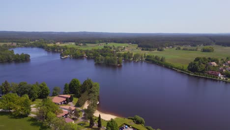 Unbelievable-aerial-top-view-flight-rural-village-Chlum-on-lake-in-czech-republic-Europe,-summer-day-of-2023