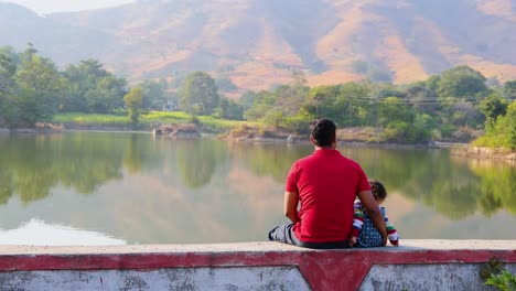 isolated young father and son enjoying nature at morning with blurred background