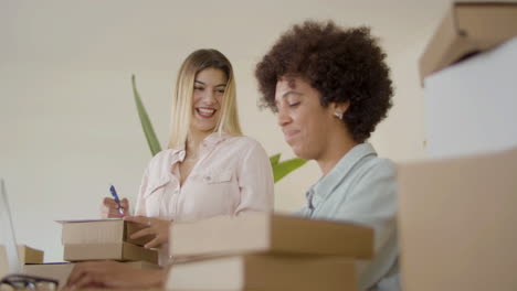 two women working in office and talking