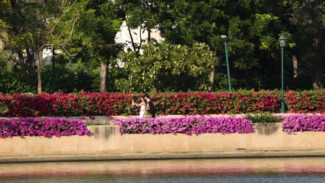 person walking by vibrant flower arrangements