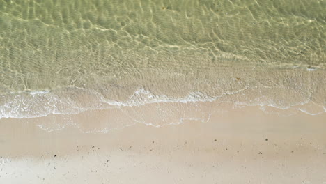 view from above of sandy shore with ocean waves at beach in dennis port, cape cod, massachusetts