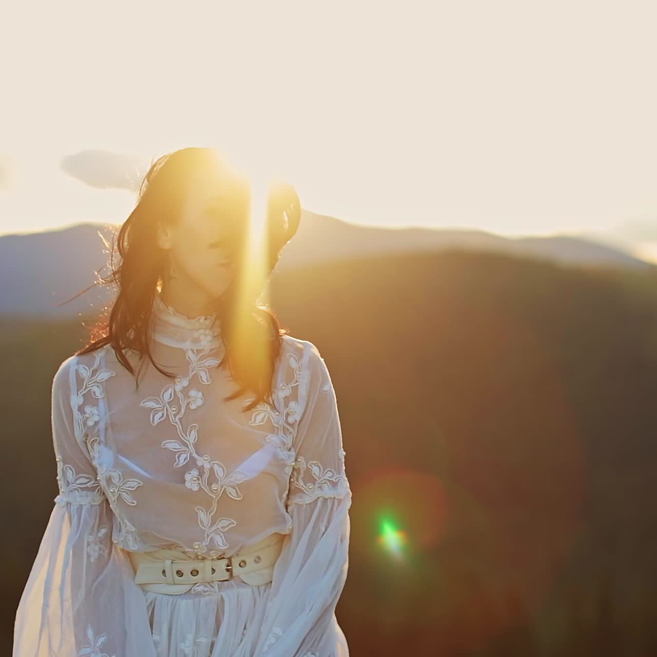 Outdoor happy woman dancing on the nature. Young beautiful lady in dress walking in mountains