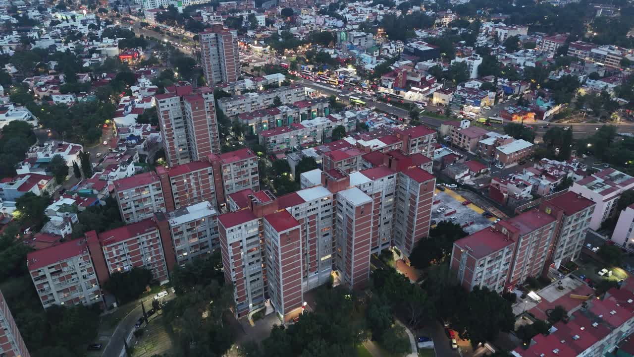 Nighttime aerial footage capturing illuminated residential condominiums in Mexico City