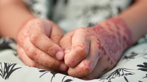 child's hands with henna designs