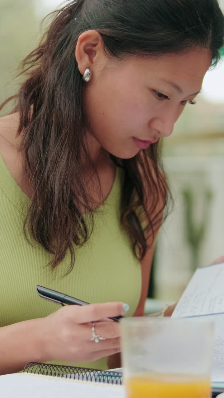 Asian female student prepares to study outdoors