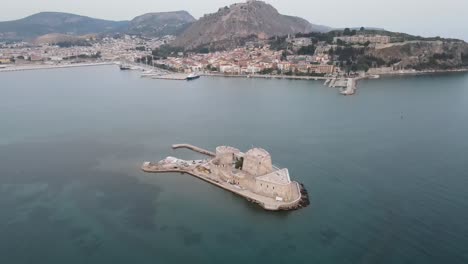 aerial drone video of venetian castle in front of palamidi fortress in nafplio town, argolida, greece