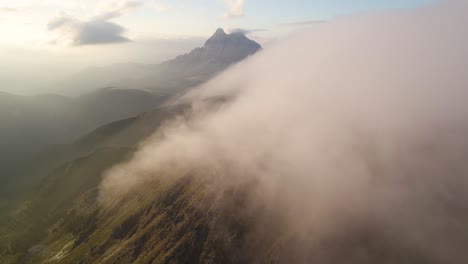 drone shot of sunrise above the clouds in