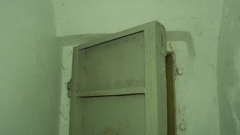 steel door inside the concrete bomb shelter to hide civil people, an underground apocalypse bunker built in old coastal fortification, medium handheld shot tilt up