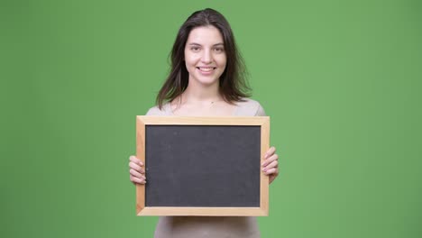 young happy beautiful woman holding blackboard