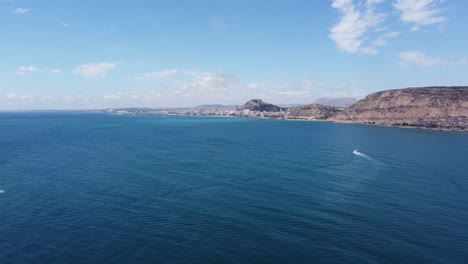 spanish limestone rocky coastline at mediterranean seaside, aerial drone