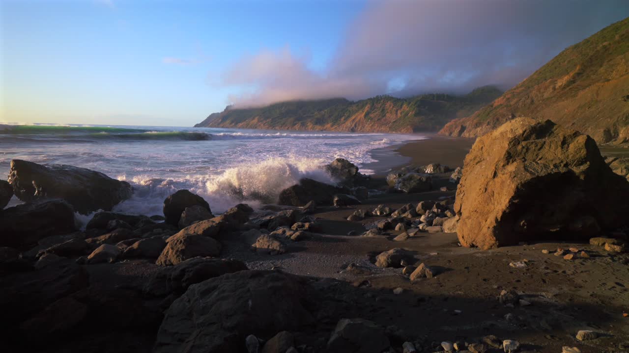 USAL Beach Campground golden sunset Pacific Ocean waves crashing rock boulders black sand California mist fog bluffs rugged lost coast remote untouched Sinkhole Wilderness nature landscape static shot