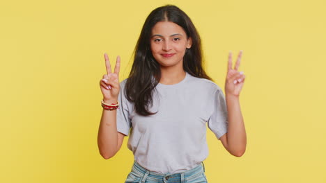 Happy-smiling-Indian-woman-girl-showing-victory-sign,-hoping-for-success-and-win-doing-peace-gesture