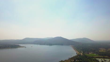 wide angle drone view of range of ramanagara hills and lake in foreground during daytime in karnataka, india.