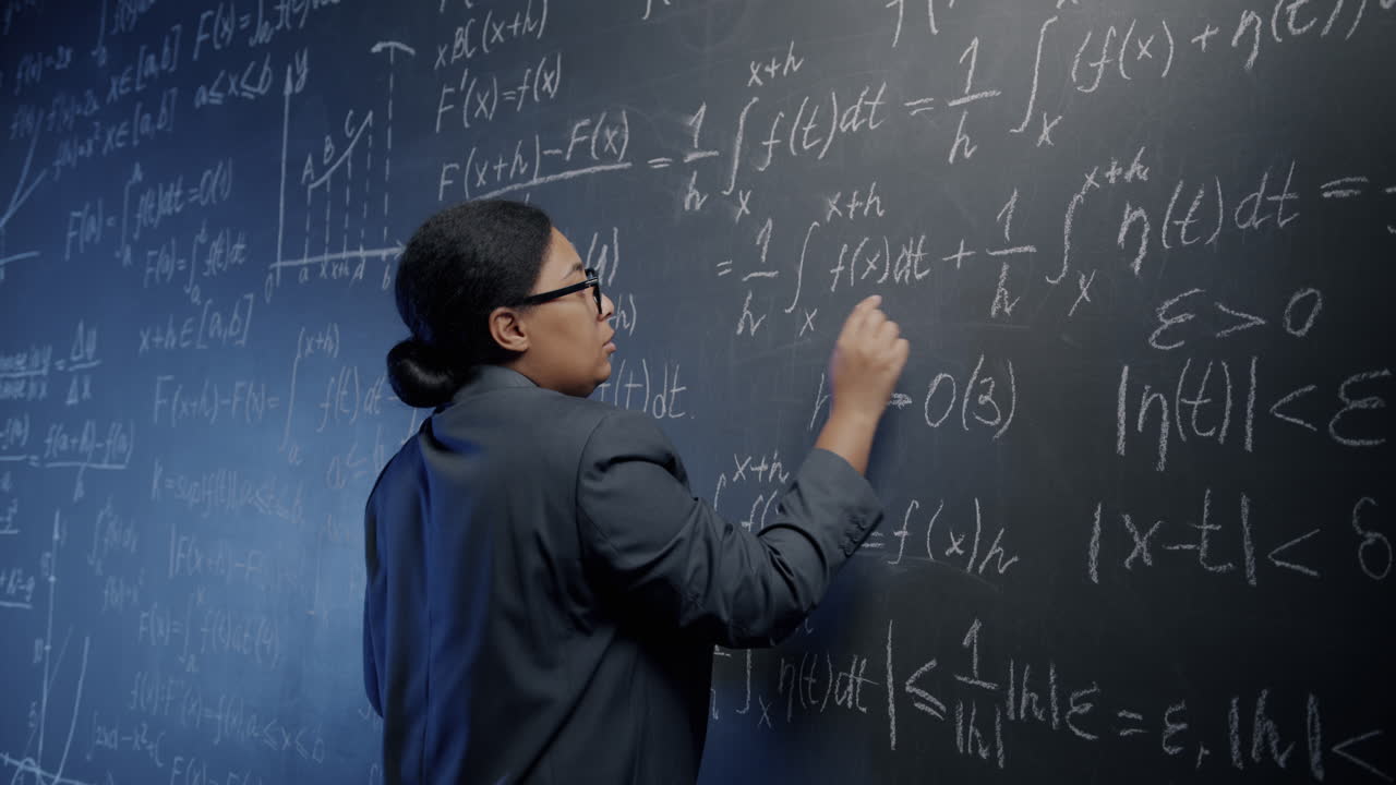 Woman Writing Equations on a Chalkboard