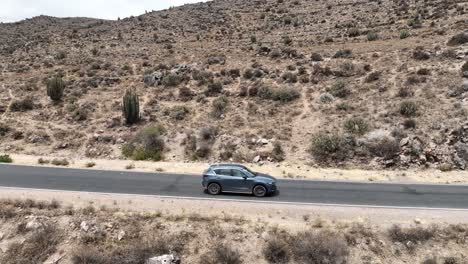 Aerial-drone-shot-of-a-moving-car-driving