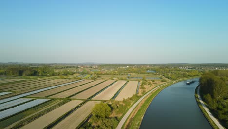 Aerial-view-in-the-sunset-of-a-river-near-Clairmarais,-France