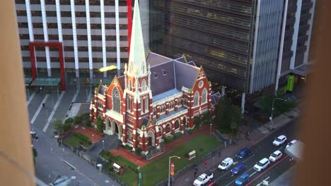 static shot from above capturing the architectural details of iconic landmark albert street uniting church and traffics on ann street at downtown brisbane city, queensland, australia