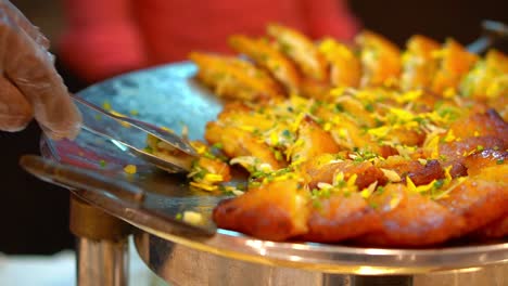 cinematic shot of malpua - traditional indian sweet pancake coated in sugar syrup made during holi and eid,top down view