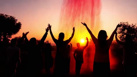 gente celebrando una colorida fuente de puesta de sol