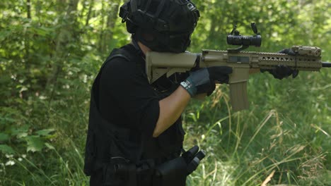 tactical guy walking in forest while looking down