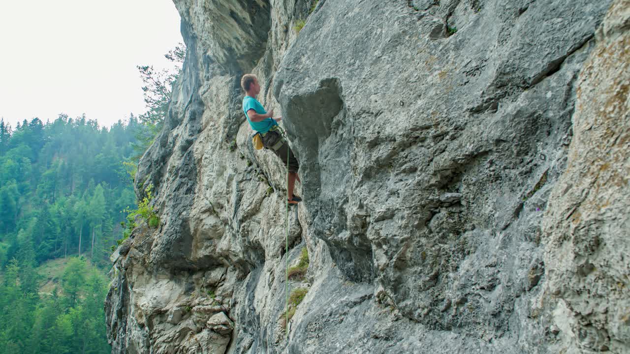 Man Climbs Up Natural Rock Formation. Extreme Sports Action