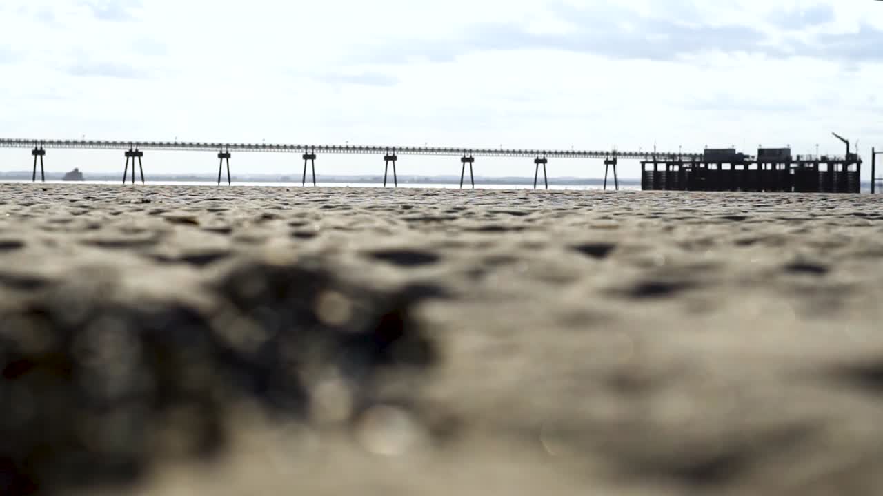 Beautiful Shot of the Pier in the daytime with a view of an amazing beach