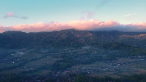 Indonesian-countryside,-majestic-cloudscape-in-background,-mountain-backdrop