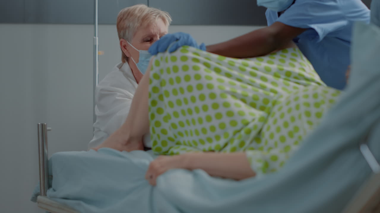 Obstetrics doctor delivering baby for caucasian woman