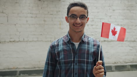 young man holding canadian flag