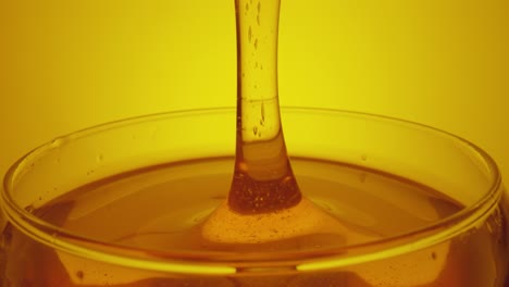 honey pouring into a bowl