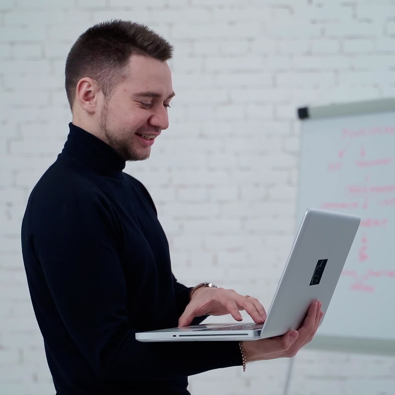 Man standing with laptop
