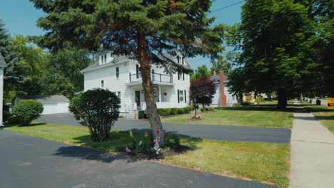 Walk-Along-The-Sidewalk-In-A-Typical-American-Neighborhood-Along-White-Wooden-Houses-And-Mowed-Lawns