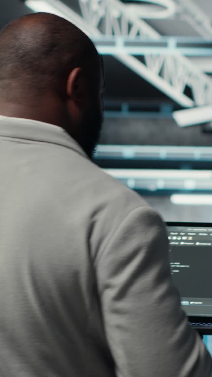 Vertical video Programmers walking in data center coding, doing optimizations using tablet