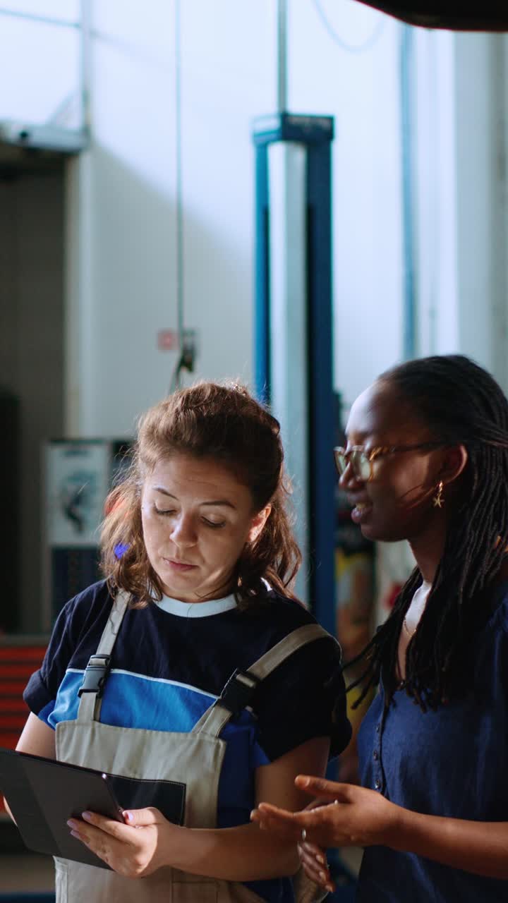 Vertical video Engineer and woman look for car parts