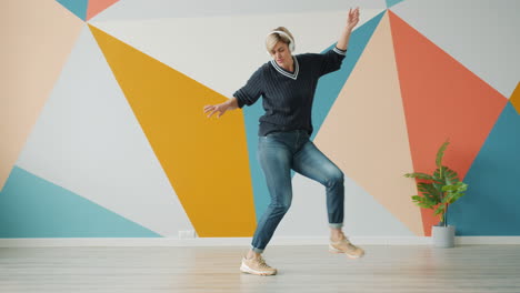 woman dancing to music in a colorful room