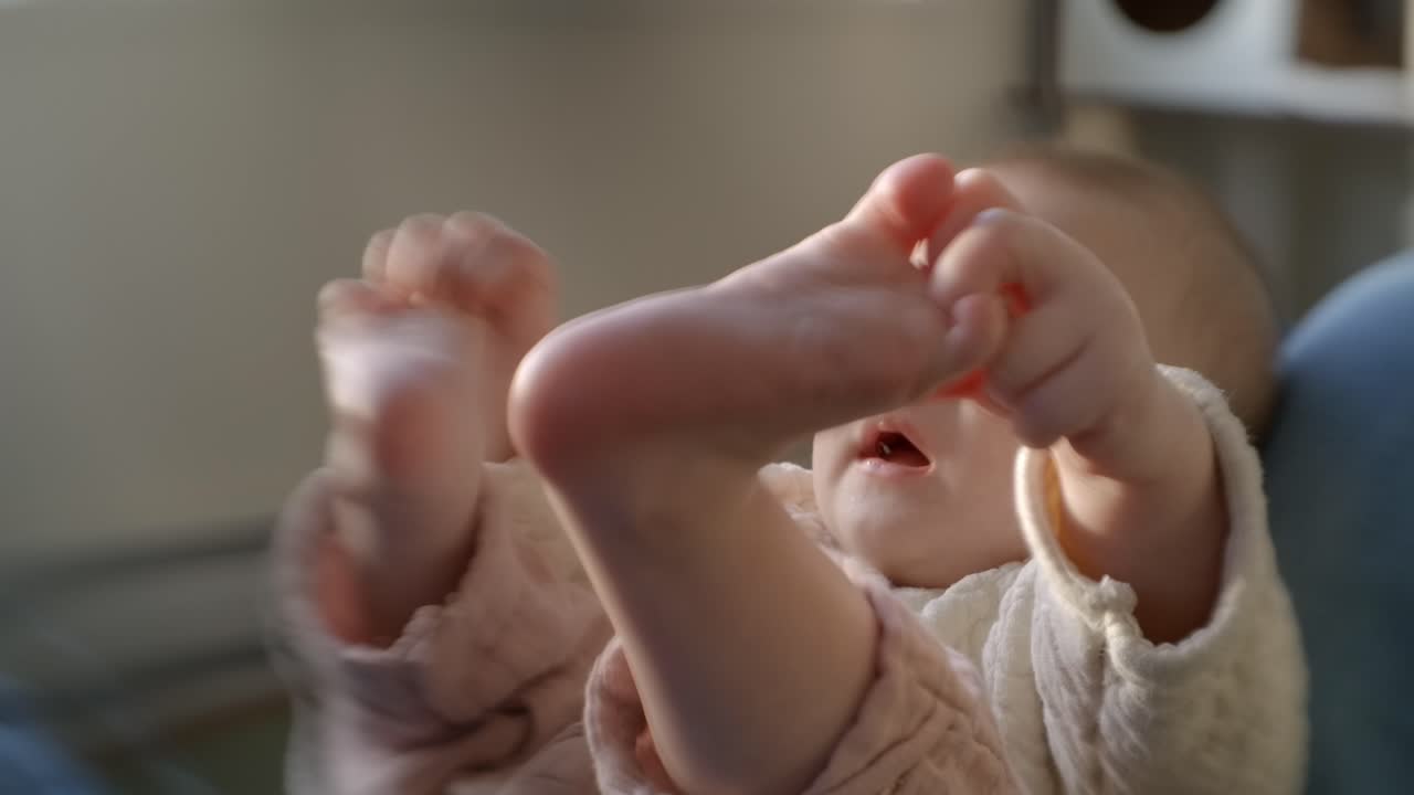 Cute Caucasian Baby Lying In Mother's Lap While Touching Her. Selective Focus Shot