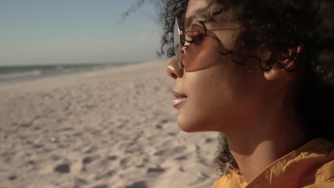 Woman in sunglasses relaxing on the beach 4k