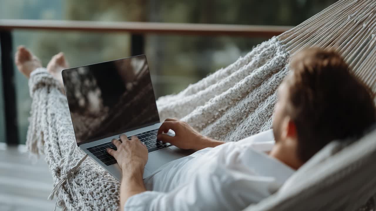 Relaxing in a Cozy Hammock, Engaged in Work on a Laptop While Enjoying a Calm and Serene Environment Surrounded by Nature's Beauty