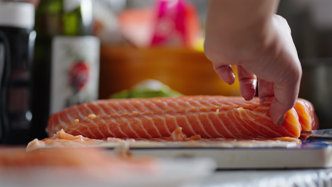 Detailed close-up of a sharp knife smoothly slicing fresh salmon with clean, steady motion