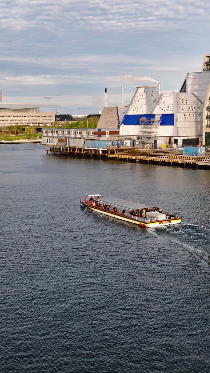 Aerial drone view of the Paper Island urban oasis surrounded by water in Copenhagen, Denmark in daylight. Vertical