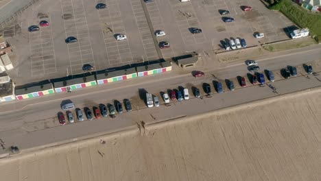 Aerial-panning-down-over-Exmouth-Beach-car-park-on-a-sunny-day